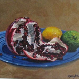 a painting of a plate of fruit, including a pomegranate that has been split open to reveal its fruit, a lemon and a lime on a blue plate. this painting is entitled pomegranate and friends and was painted by martha dodd