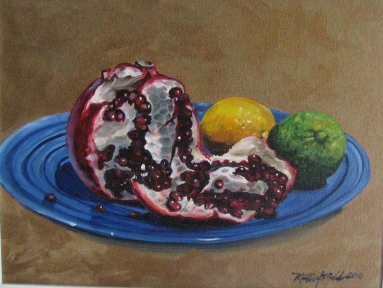 a painting of a plate of fruit, including a pomegranate that has been split open to reveal its fruit, a lemon and a lime on a blue plate. this painting is entitled pomegranate and friends and was painted by martha dodd