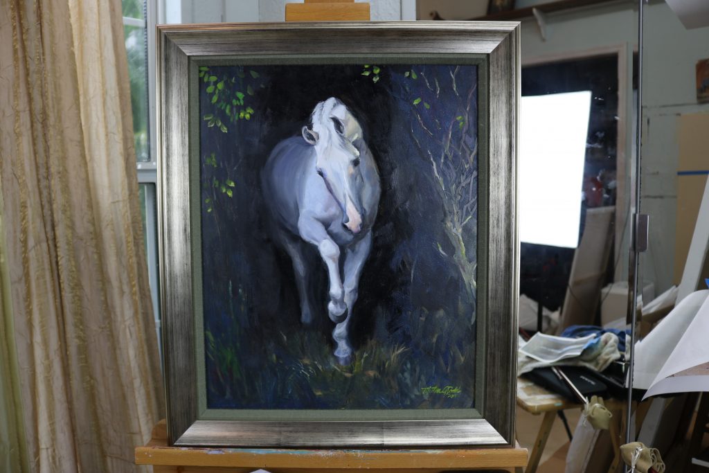 picture of a white horse paiinting on an easel