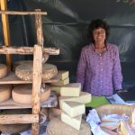 A lady selling her cheese.