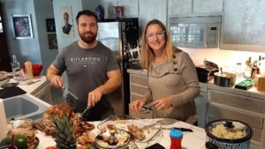 martha dodd in the kitchen with her son jackson dodd carving the turkey