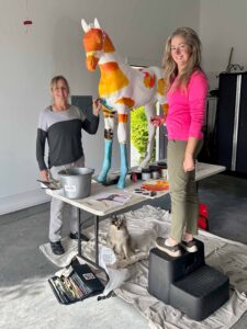 Martha and Natasha painting a horse sculpture