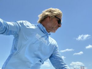 marc with a light blue shirt against a blue sky